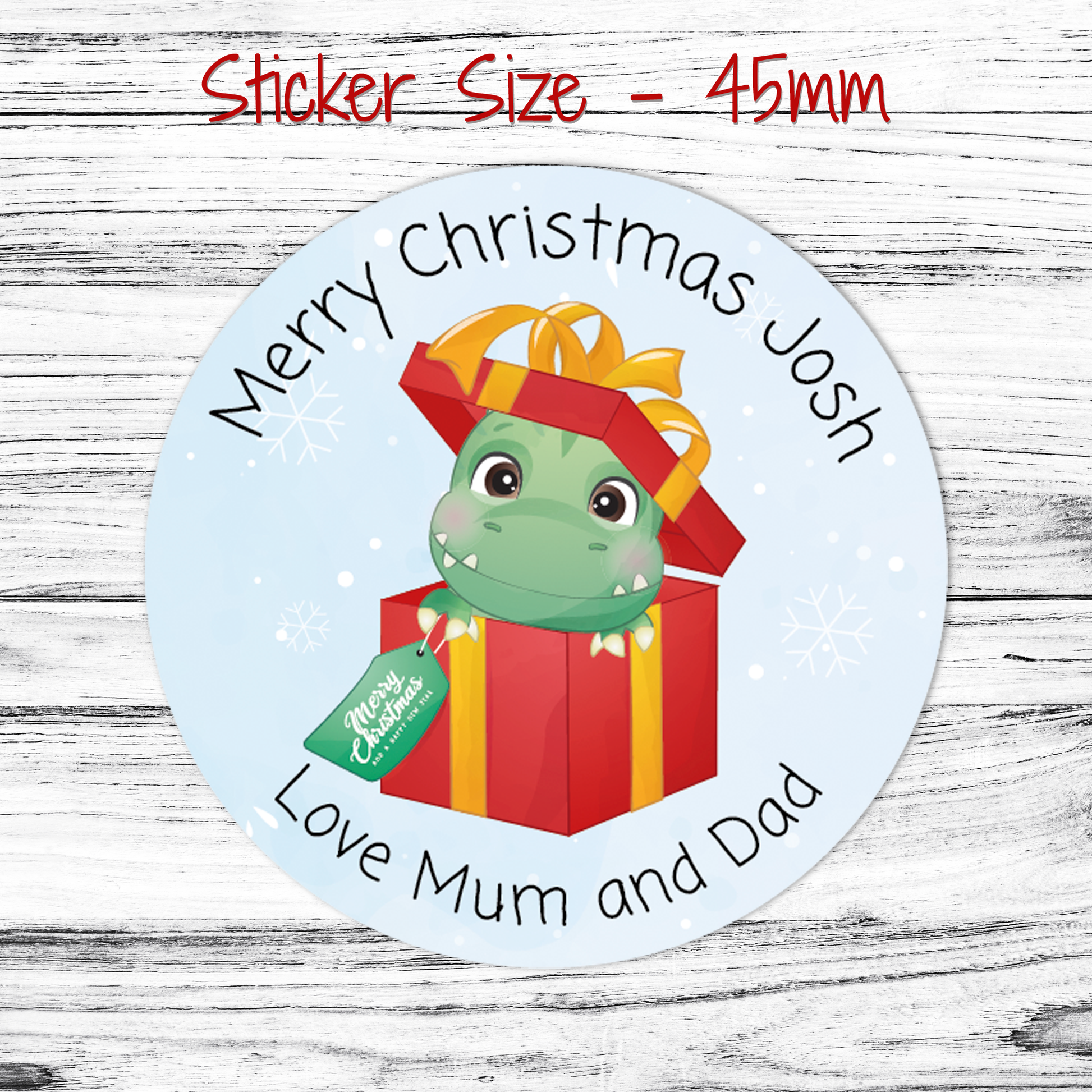 Personalised round Christmas sticker with a dinosaur in a present box